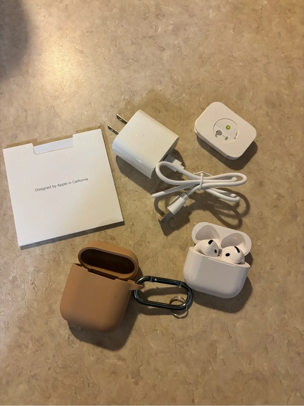 Apple AirPods Pro with White Earbuds and Tan Silicone Case
